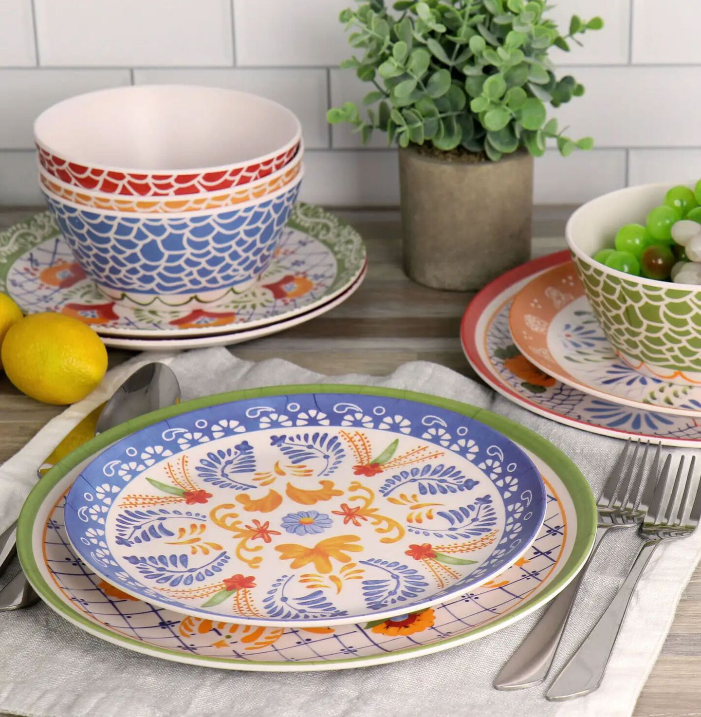 Place setting with colorful blue, green, yellow and red patterned plates and bowls